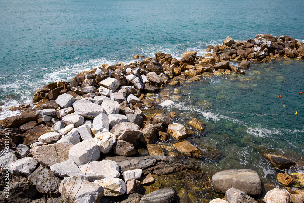 View on water of Ligurian Sea and rocks, picturesque landscape, Riomaggiore, Cinque Terre, Italy View on water of Ligurian Sea and rocks, picturesque landscape, Riomaggiore, Cinque Terre, Italy