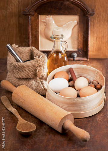 Cook at home. Wooden spoons, spatulas, kitchen utensils on a wooden table. Simple products - flour and eggs on wooden table