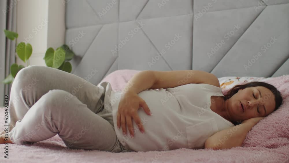 Pregnant woman cannot fall asleep from abdominal pain. Expectant mother