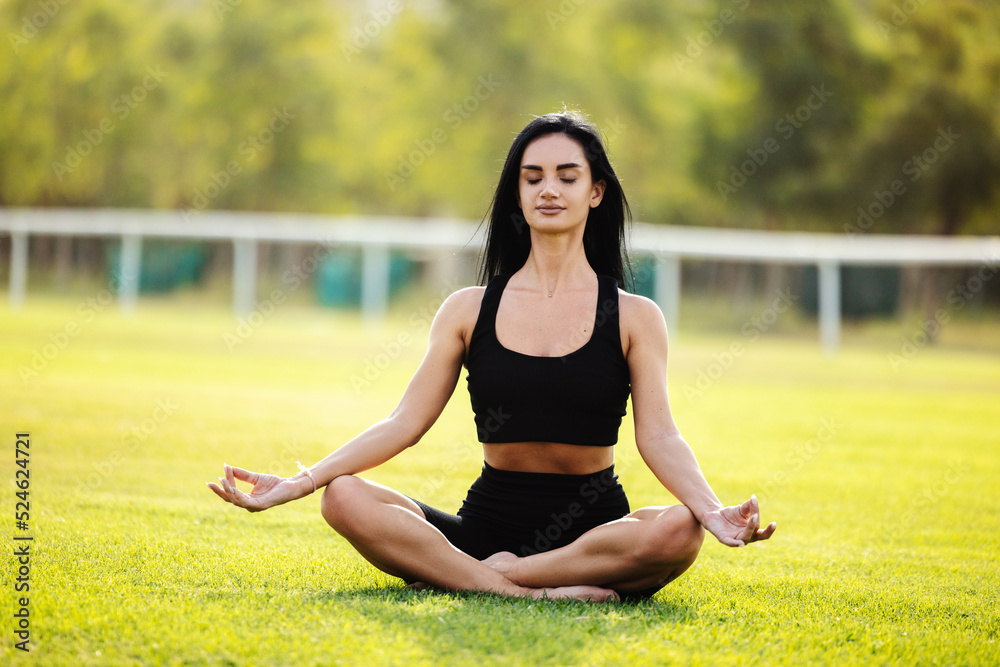 Woman sitting in lotus asana Woman sitting in lotus asana