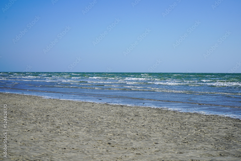 View of the ocean lapping on a sandy shore 