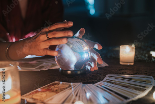 Photography Fortune teller with illuminated crystal ball and tarot cards to prediction future