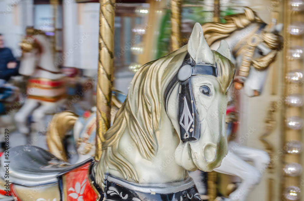 The decorations on the children's carousel with wooden horses