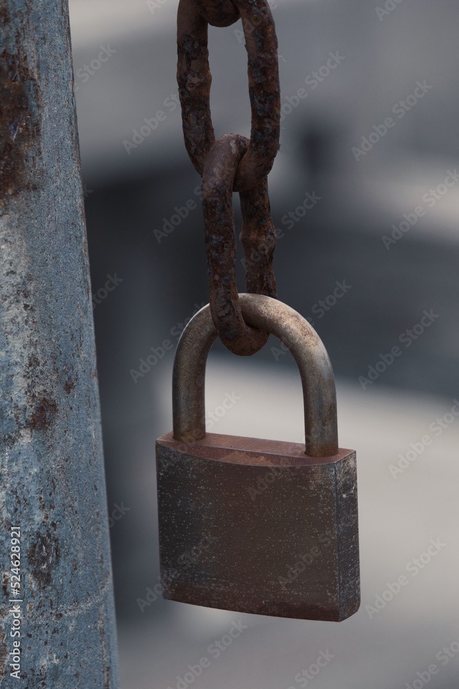 Padlock hanging off a broken chain Padlock hanging off a broken chain