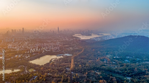 Aerial photography of Meiling Palace Scenic Spot in Nanjing City, Jiangsu Province, China in autumn and the Nanjing urban building complex in the distance © Changyu