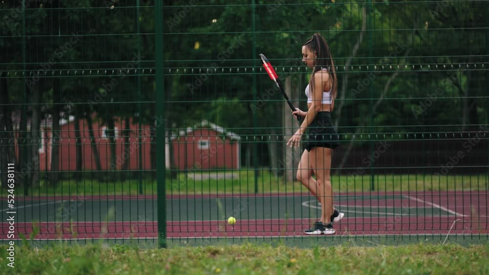 young female tennis player is training alone on court outdoor, sport activities and keeping fit