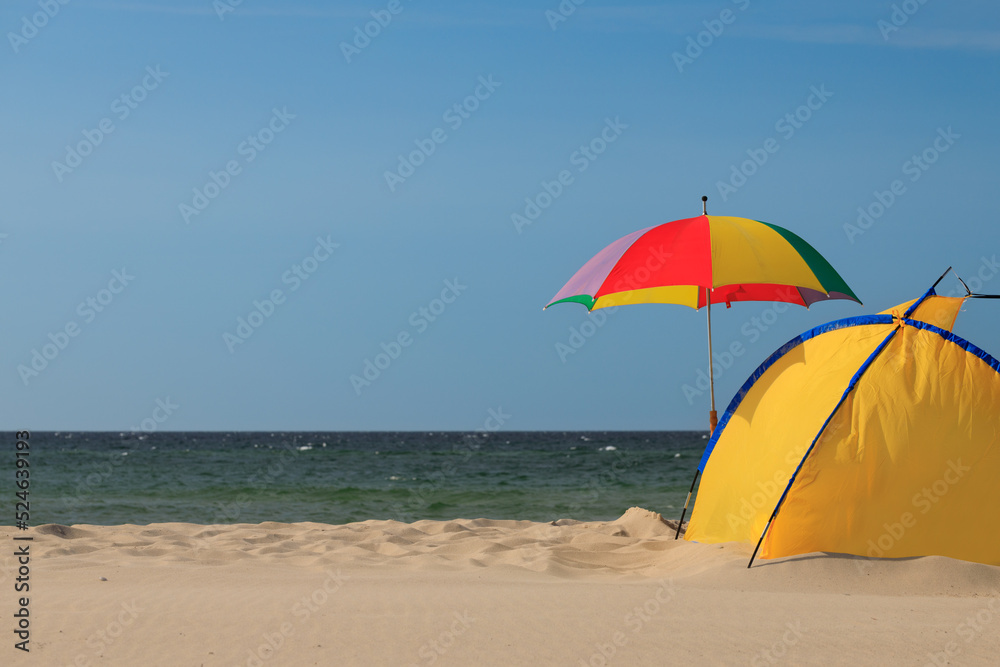 Mockup of summer landscape with beach umbrella. Blue sea or ocean background. Summer holiday concept. Beautiful beach banner.