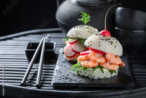 Delicious sushi burger with seafood and rice as Japanese appetizers.