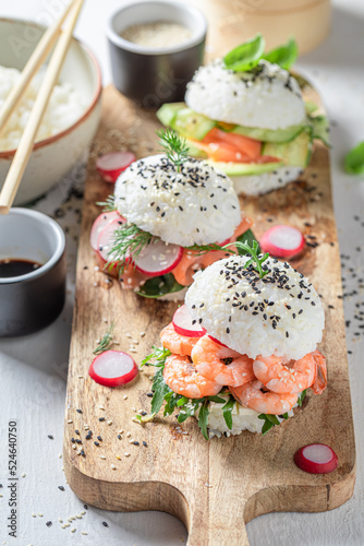 Healthy sushi burger with seafood and rice on strone plate. photo