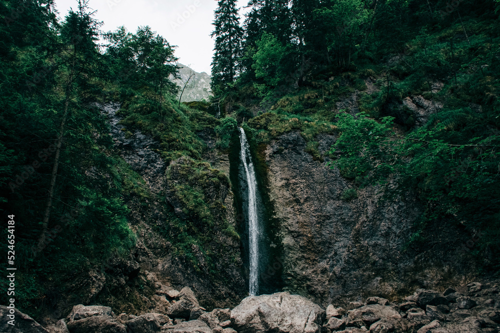 Small mountain waterfall in Europe falls from a cliff. Pictures for wallpaper. Small mountain waterfall in Europe falls from a cliff. Pictures for wallpaper.