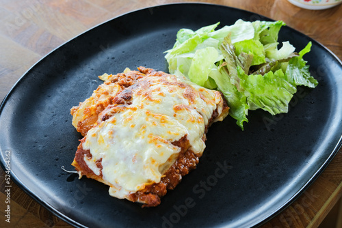 Italian Lasagna with melted cheese and lettuce photo