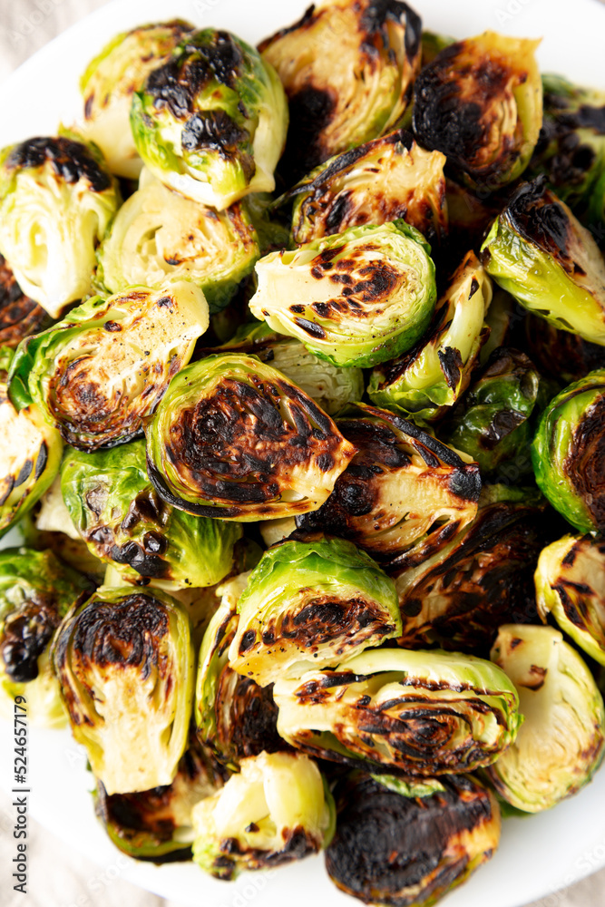 Homemade Roasted Brussel Sprouts on a Plate, top view. Flat lay, overhead, from above. Close-up. Homemade Roasted Brussel Sprouts on a Plate, top view. Flat lay, overhead, from above. Close-up.