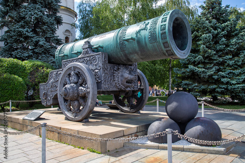 View of the Tsar cannon on a carriage with cast-iron cores against the background of green trees in the Kremlin, Moscow. Sights of Russia. Architecture of World Tourism.