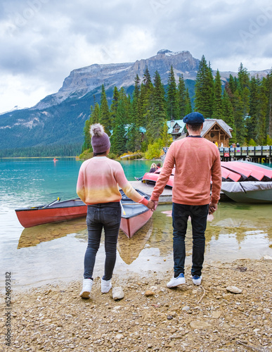 Emerald lake Yoho national park Canada British Colombia. beautiful lake in the Canadian Rockies during the Autumn fall season. Couple of men and women standing by the lake photo