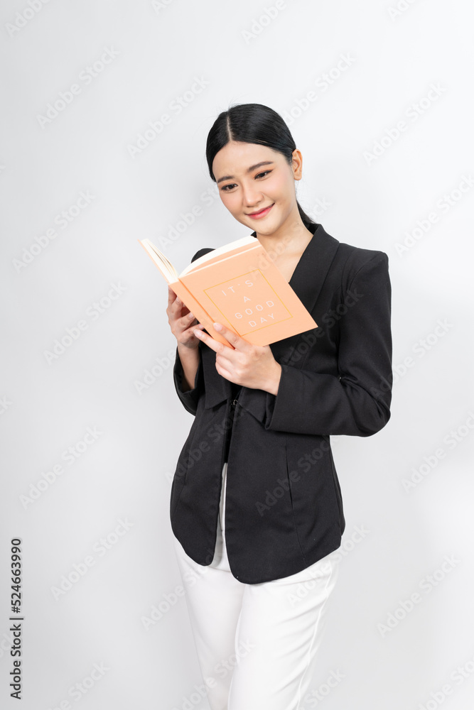 Portrait photo of a young beautiful and elegant asian woman holding a note book with a good nice friendly smile and different poses and emotion Portrait photo of a young beautiful and elegant asian woman holding a note book with a good nice friendly smile and different poses and emotion