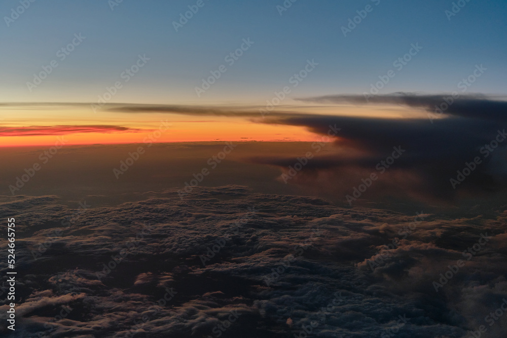 clouds photographed from the window curtain of an airplane