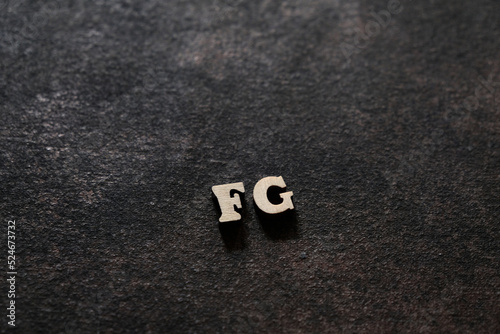 The letters F and G above the dark field. Initials FG