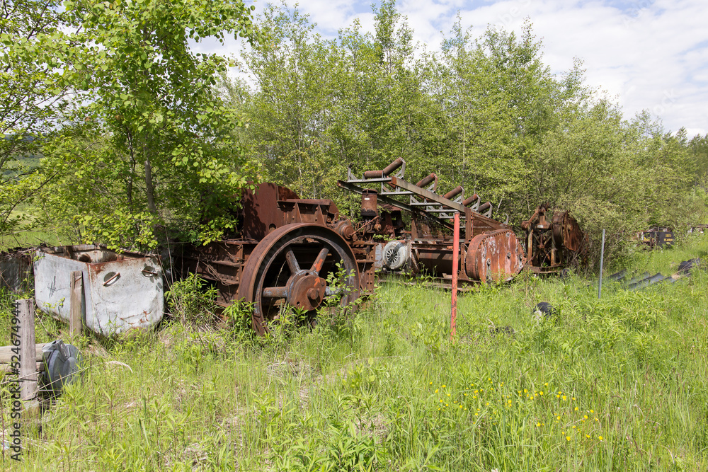 A pile of rusty junk and old mining equipment store and lost in the nature