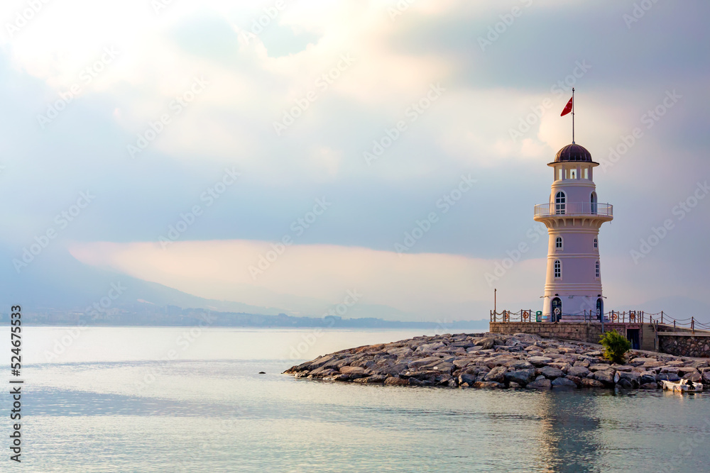 The old lighthouse in the port of the Turkish city of Alanya at sunrise. Copyspace