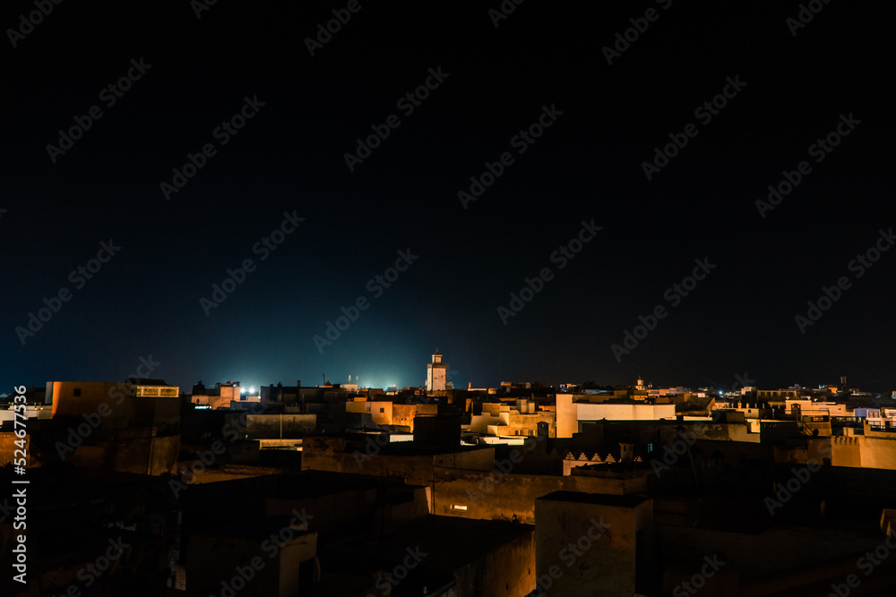 night cityscape view of Essaouira city buildings and mosque, Morocco