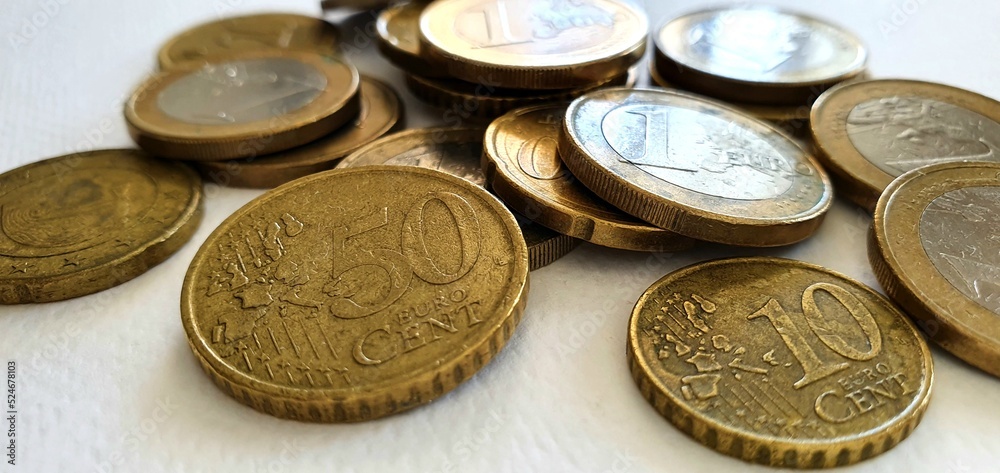 Euro coins on a white background. Money background. Euro currency in Europe. One euro, fifty cents, twenty cents and ten cents. Euro coins in a spoon. Euro coins on a white background. Money background. Euro currency in Europe. One euro, fifty cents, twenty cents and ten cents. Euro coins in a spoon.