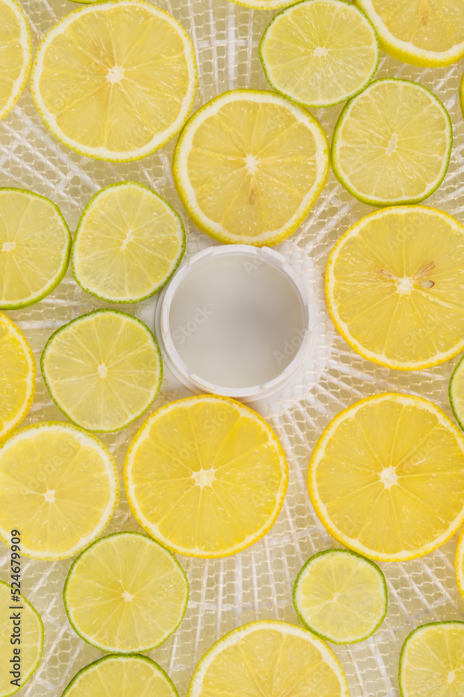 fresh, juicy lemon slices in a tray for making dried fruits on a white background, top view, close-up