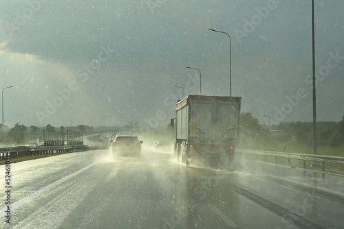 Obraz na płótnie Cars on the highway on a rainy day. Lots of water drops. Concept of safe driving w salonie