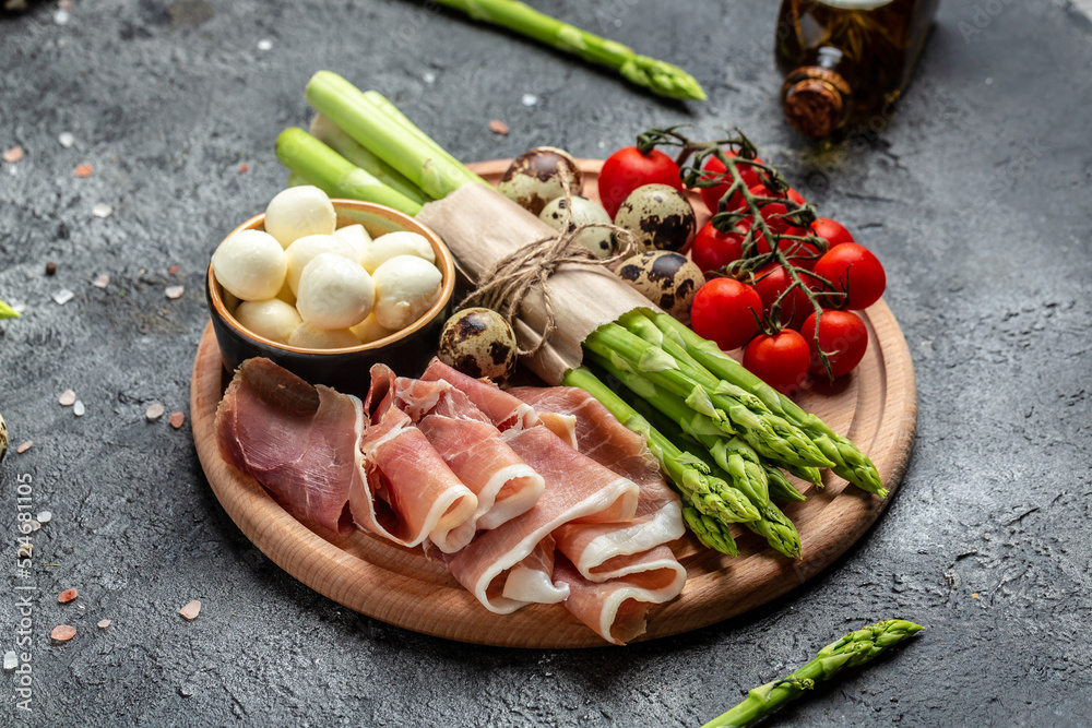 prosciutto with mozzarella cheese and cherry tomatoes. healthy food concept. Restaurant menu, dieting, cookbook recipe top view prosciutto with mozzarella cheese and cherry tomatoes. healthy food concept. Restaurant menu, dieting, cookbook recipe top view