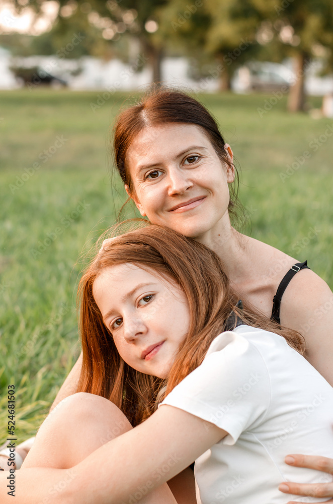 Portrait of a mother with her daughter in nature. Mother and daughter are having fun Portrait of a mother with her daughter in nature. Mother and daughter are having fun