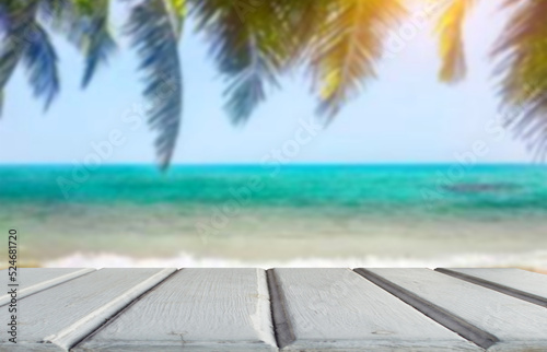 White wooden table top on blur the blue sea or beach.Summer daytime concept.For montage product display or design key visual layout.View of copy space. © Kiie