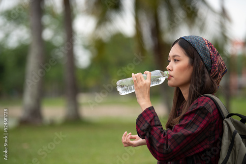 beautiful woman drinking pure water from a bottle