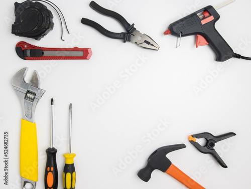 Top view of construction tools and tools highlighted on a white background with a space in the center