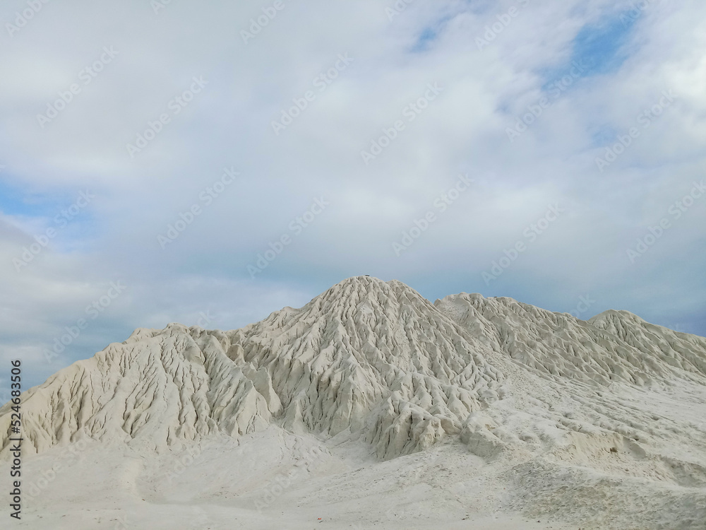 Kaolin quarry, view of industrial clay hills, environment after mining. Pile of Kaolin near of Kaolin lake in Belitung.