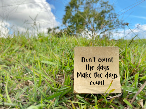 Don't count the days make the days count text on paper with nature background. Inspirational and Motivational Concept. © Frederica Aban