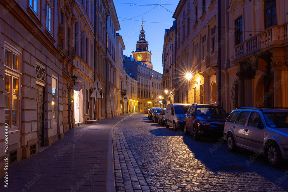 Krakow. Old houses in night illumination at dawn.