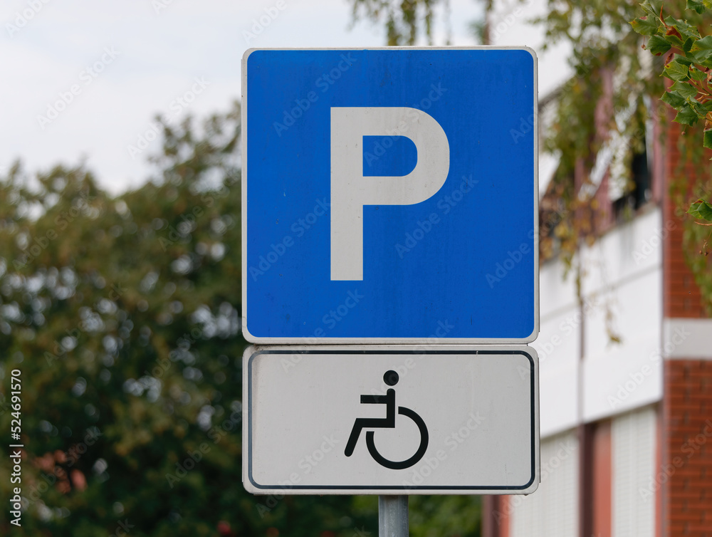 Close-up shot of a handicapped parking sign attached on a metal pole Close-up shot of a handicapped parking sign attached on a metal pole