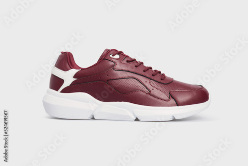 Classic fashion leather women's burgundy pair of sneakers shoes for fitness gym running jogging isolated on white background, placed together