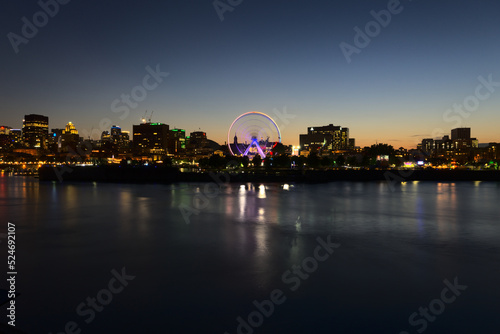 Long exposure of Montreal Downtown skyline during the twilight blue hour with motion blur of Montreal Grand Ferris Wheel