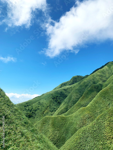 beautiful valley landscape view with blue sky and green mountain in nature background