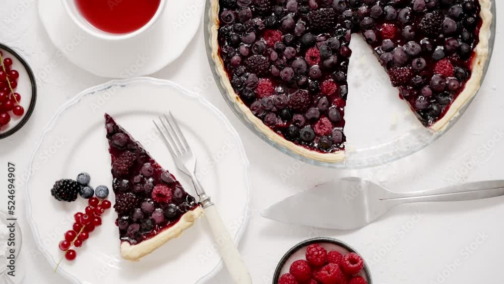 Delicious homemade piece on a plate and the whole homemade forest berry tart Delicious homemade piece on a plate and the whole homemade forest berry tart