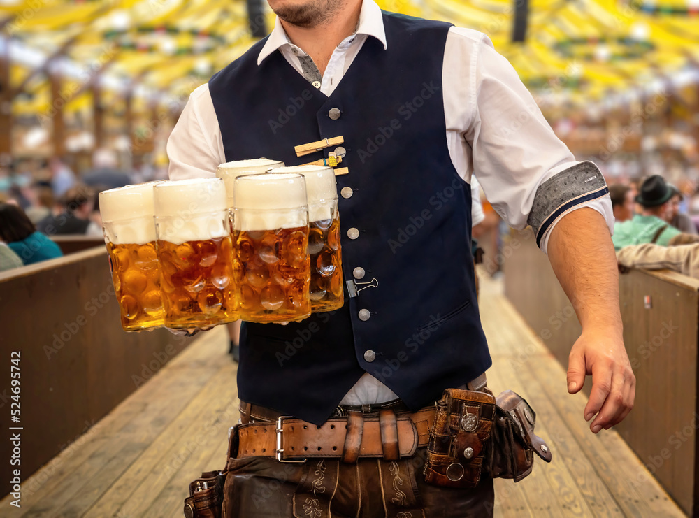 Obraz premium Oktoberfest, Munich. Waiter serve beer, close up. Octoberfest German festival.