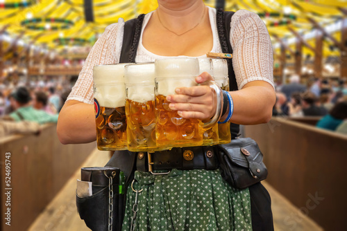 Oktoberfest, Munich. Waiter serve beer, close up. Octoberfest German festival.