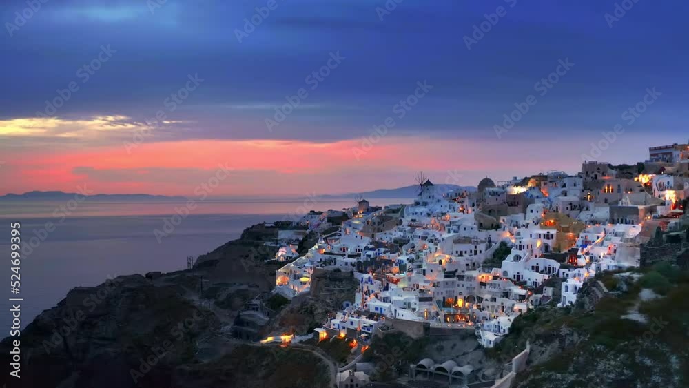 Santorini Greece sunset view of Oia town. Greek island of Aegean sea at dusk Santorini Greece sunset view of Oia town. Greek island of Aegean sea at dusk