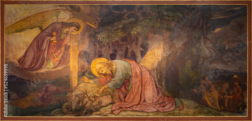 BERN, SWITZERLAND - JUNY 27, 2022: The fresco of prayer of Jesus in Gethsemane garden in the church Dreifaltigkeitskirche by August Müller (1923). photo