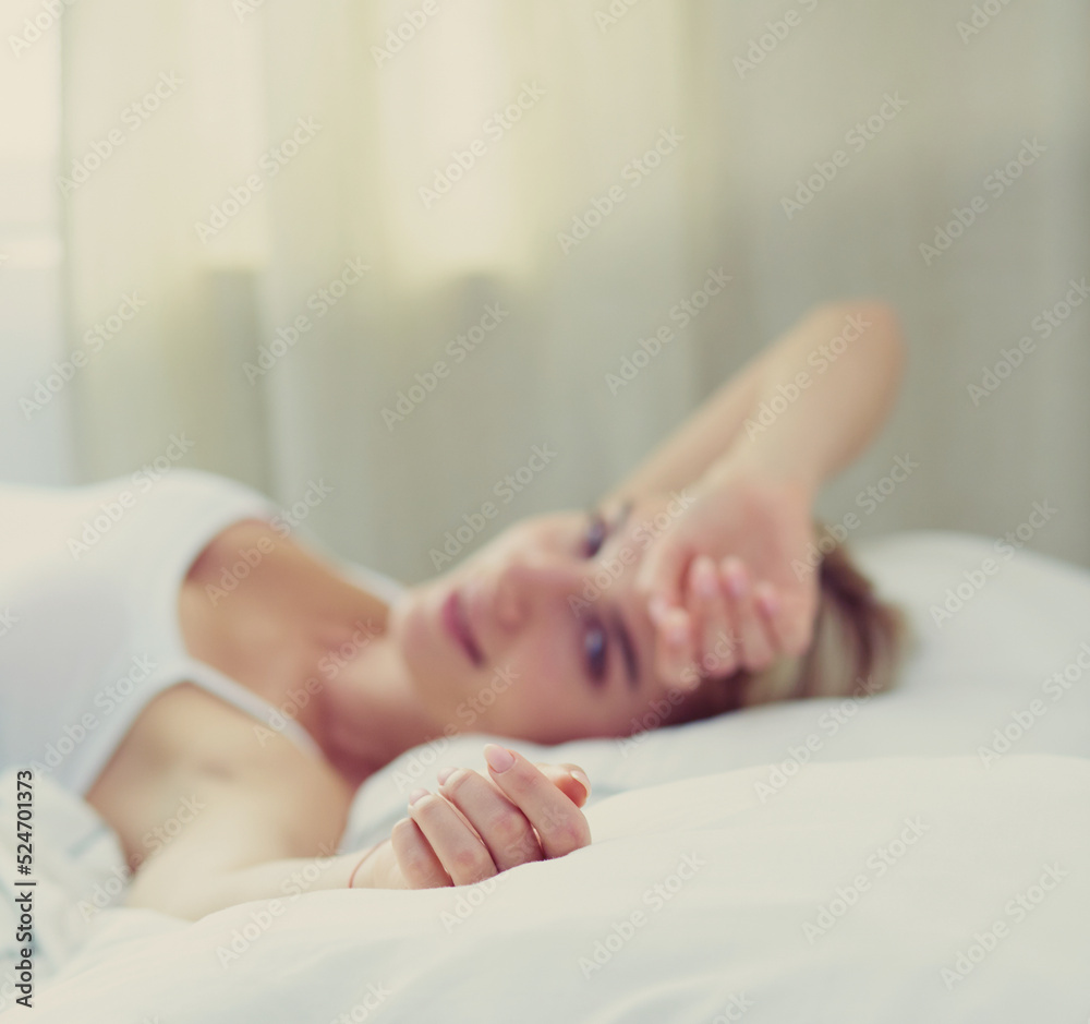 Pretty woman lying down on her bed at home Pretty woman lying down on her bed at home