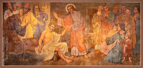 BERN, SWITZERLAND - JUNY 27, 2022: The fresco of Christ at the healing in the church Dreifaltigkeitskirche by August Müller (1923).