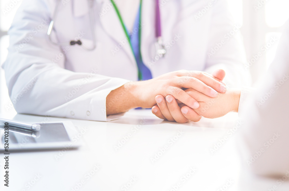 Close-up of stethoscope and paper on background of doctor and patient hands Close-up of stethoscope and paper on background of doctor and patient hands