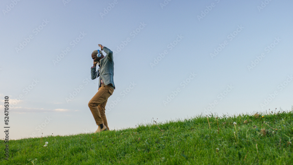 Portrait of older black male dancing as he listens to music through headphones Portrait of older black male dancing as he listens to music through headphones