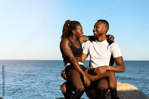 African american couple laughing and looking at each other after sport