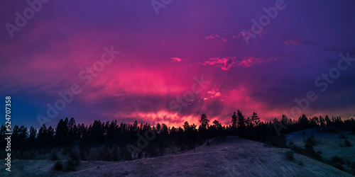 Blazing sunset cloudscape over the forest hill in Canadian National Park